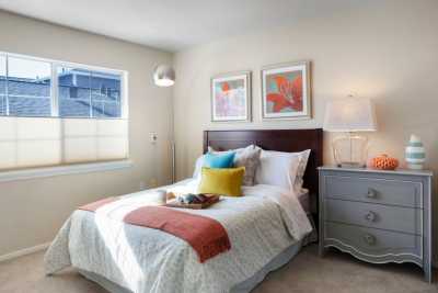 A cozy bedroom with vibrant decor and artwork.