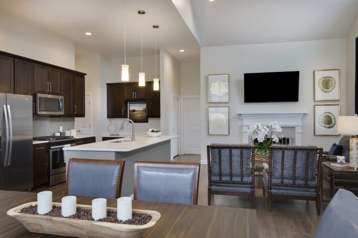 A modern open-concept kitchen and dining area with stylish furnishings and contemporary lighting.