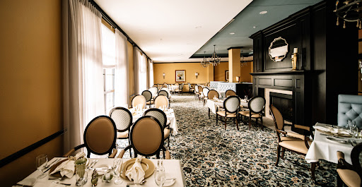 An elegantly designed dining room featuring plush seating and a warm color palette.