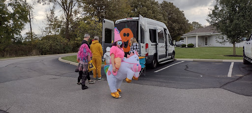 A festive gathering showcasing colorful costumes and decorations, celebrating Halloween.