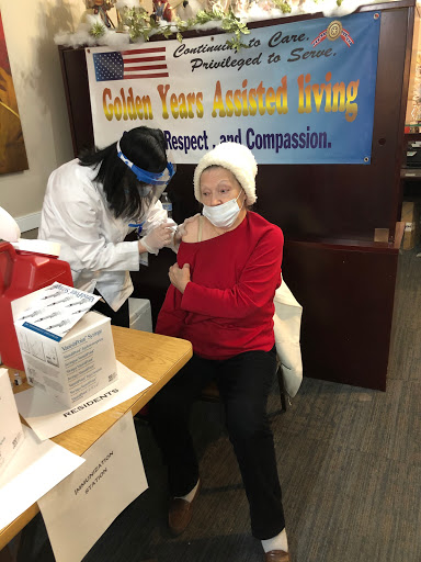 A healthcare professional administering a vaccination to an elderly individual at a community clinic.