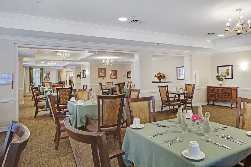 A well-decorated dining room with tables and chairs arranged neatly.