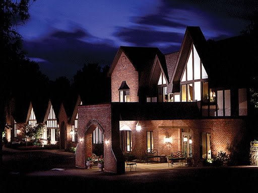 A beautifully lit residential building showcasing modern architectural design at night.