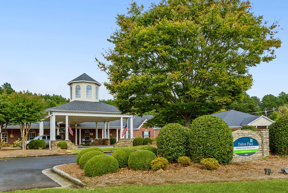 A scenic view of a building surrounded by lush greenery and well-maintained landscaping.