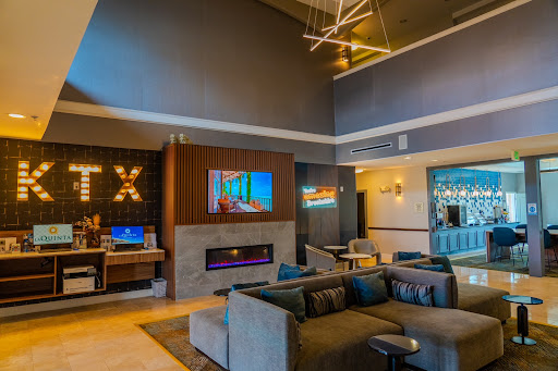 A stylish modern lounge featuring comfortable seating and a contemporary fireplace.