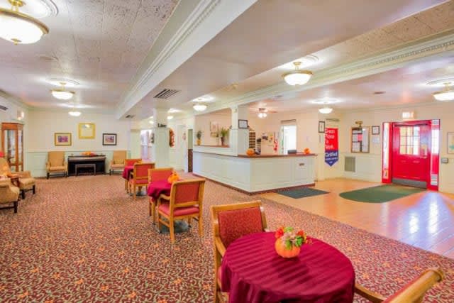 A welcoming hotel lobby with a reception desk and seating area.