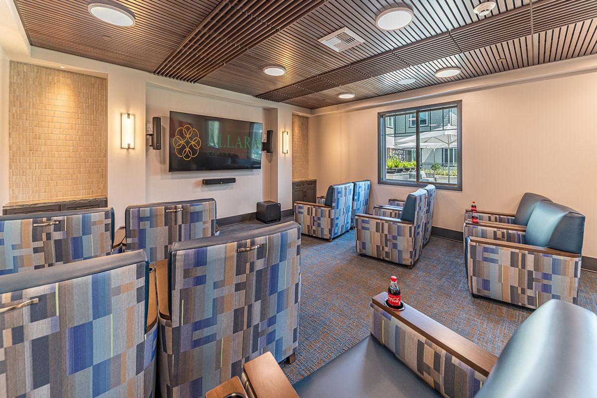 A modern lounge with comfortable seating and a large television.