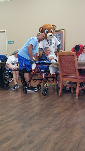 Residents and caregivers enjoying a lively activity session together in an assisted living facility.