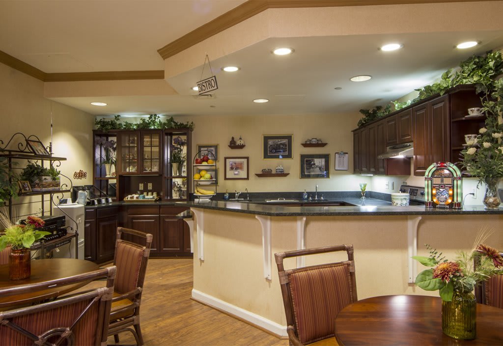 A cozy kitchen and dining area with elegant furnishings and warm lighting.
