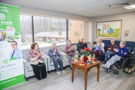 Elderly residents enjoying a lively gathering in a community center, engaging in activities and celebrating together.