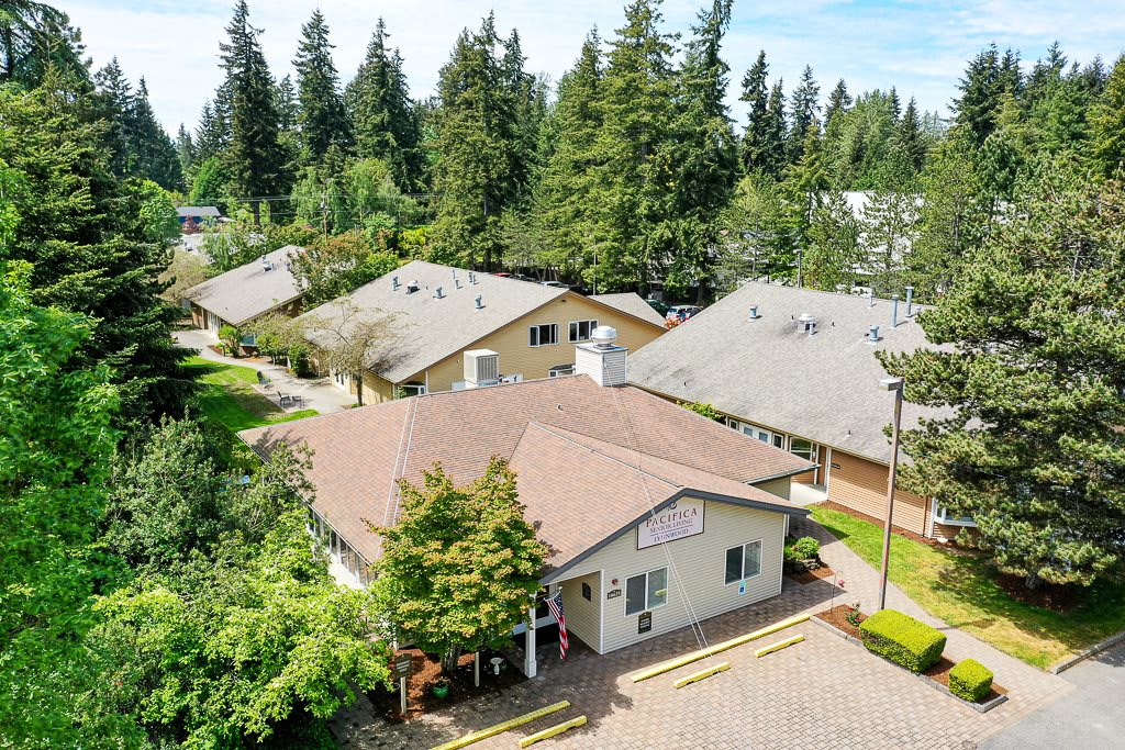 Aerial view of a residential area surrounded by trees.
