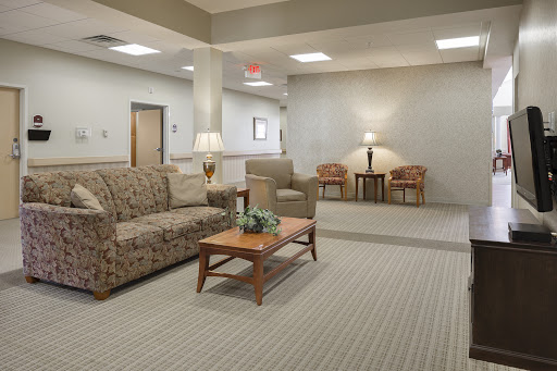 A cozy living room area featuring a sofa, coffee table, and soft lighting.