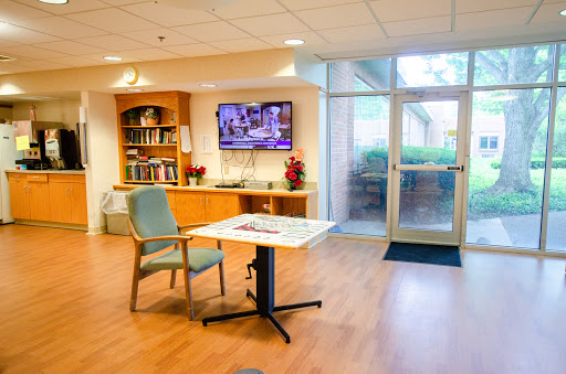 A cozy interior space featuring a chair, table, and a television, perfect for relaxation or social gatherings.