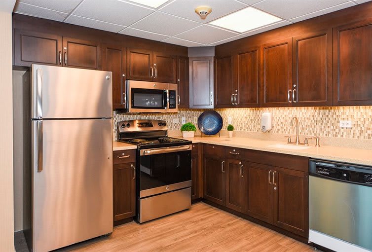 A modern kitchen with stainless steel appliances and wooden cabinets.