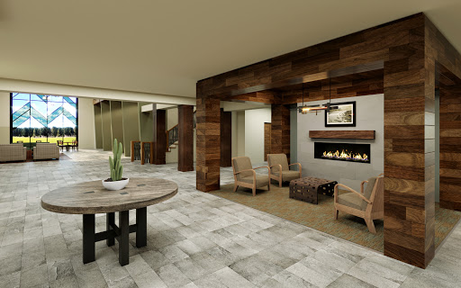 A warm and inviting lobby space featuring a modern fireplace and comfortable seating.