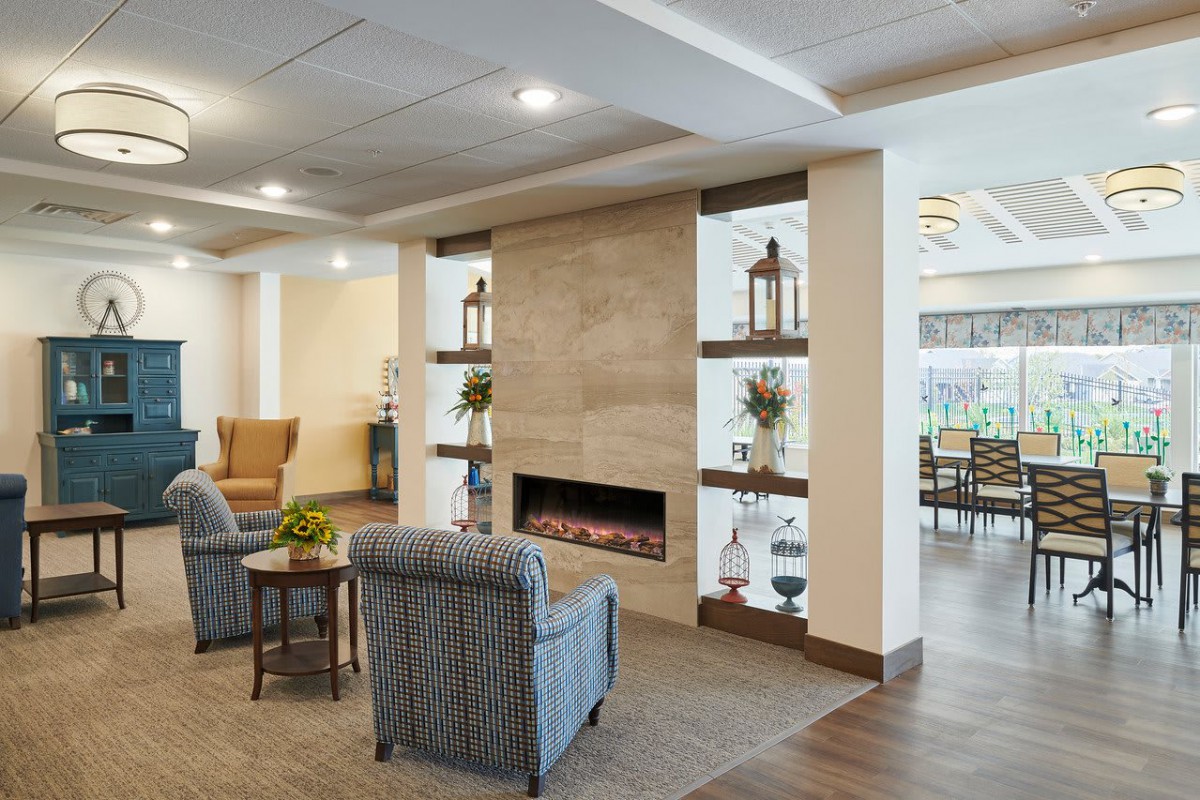 A modern lounge area with a fireplace, comfortable seating, and elegant decor.