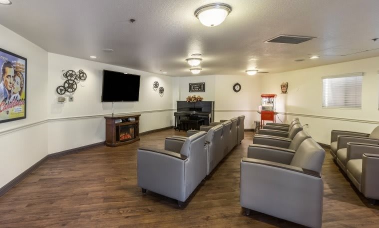 A cozy indoor living room with comfortable seating and a large television setup.