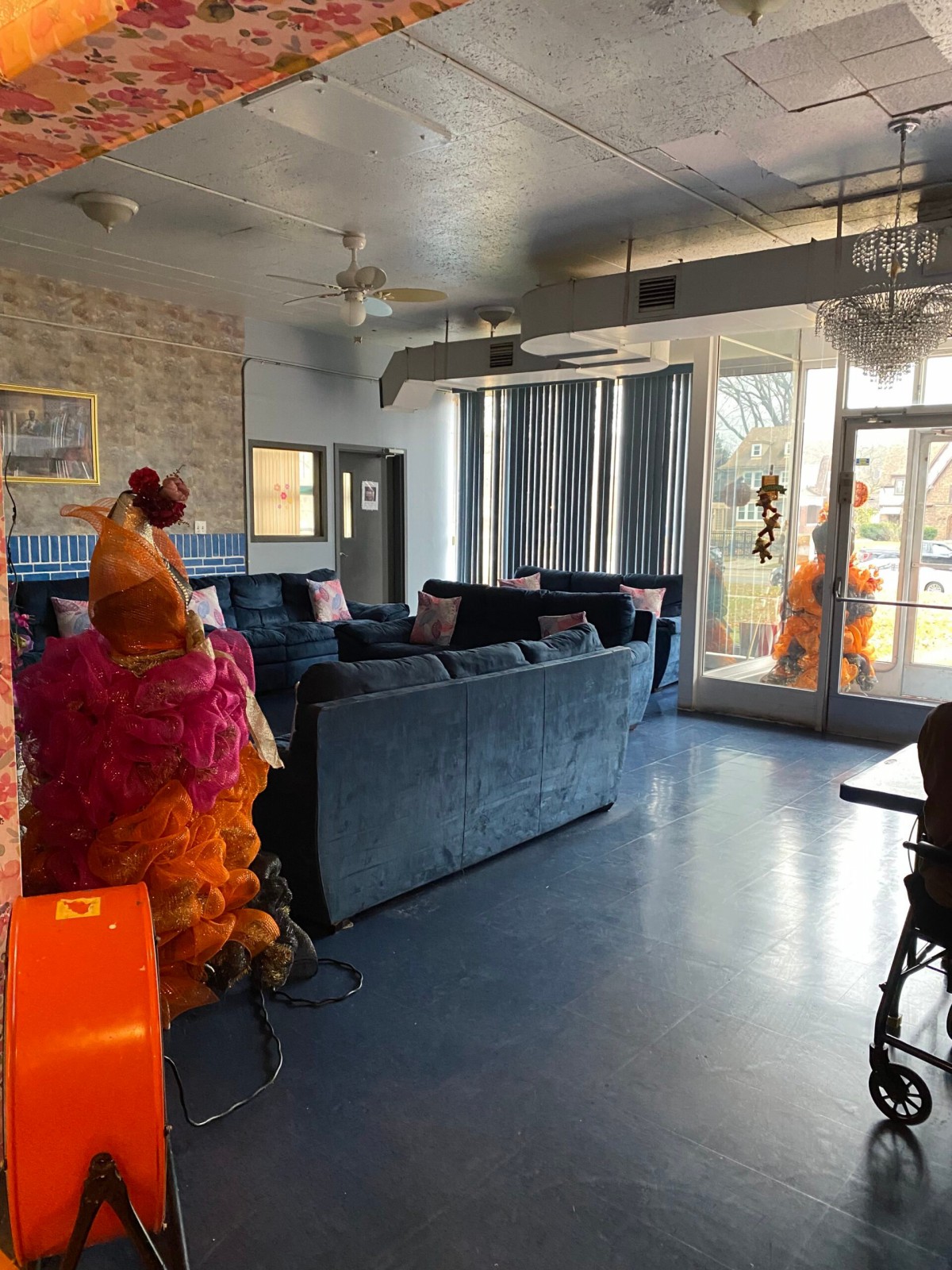 A brightly decorated interior lounge area featuring colorful costumes and modern furniture.