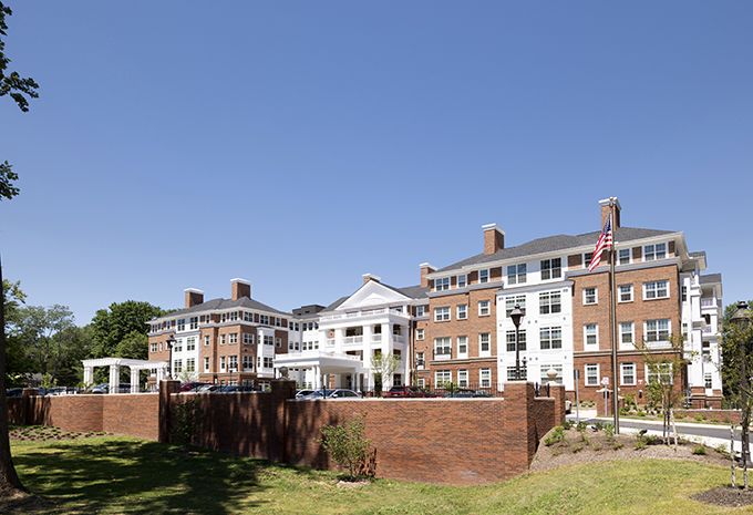 A large, historic brick building under a clear blue sky.