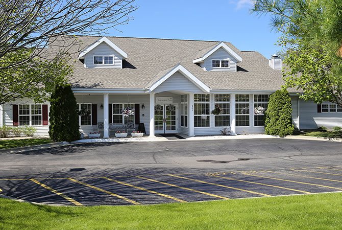 A commercial building with a parking lot in front.