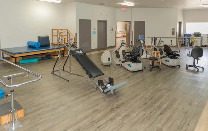 A spacious gym with various exercise equipment for fitness training.