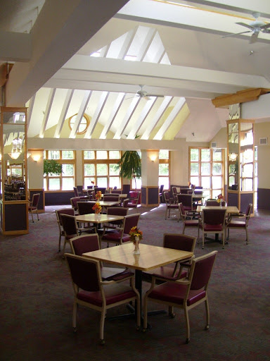 A spacious and well-lit dining area featuring modern furniture and a welcoming ambiance.