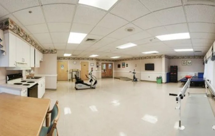 A spacious gym with exercise equipment and a clean interior.