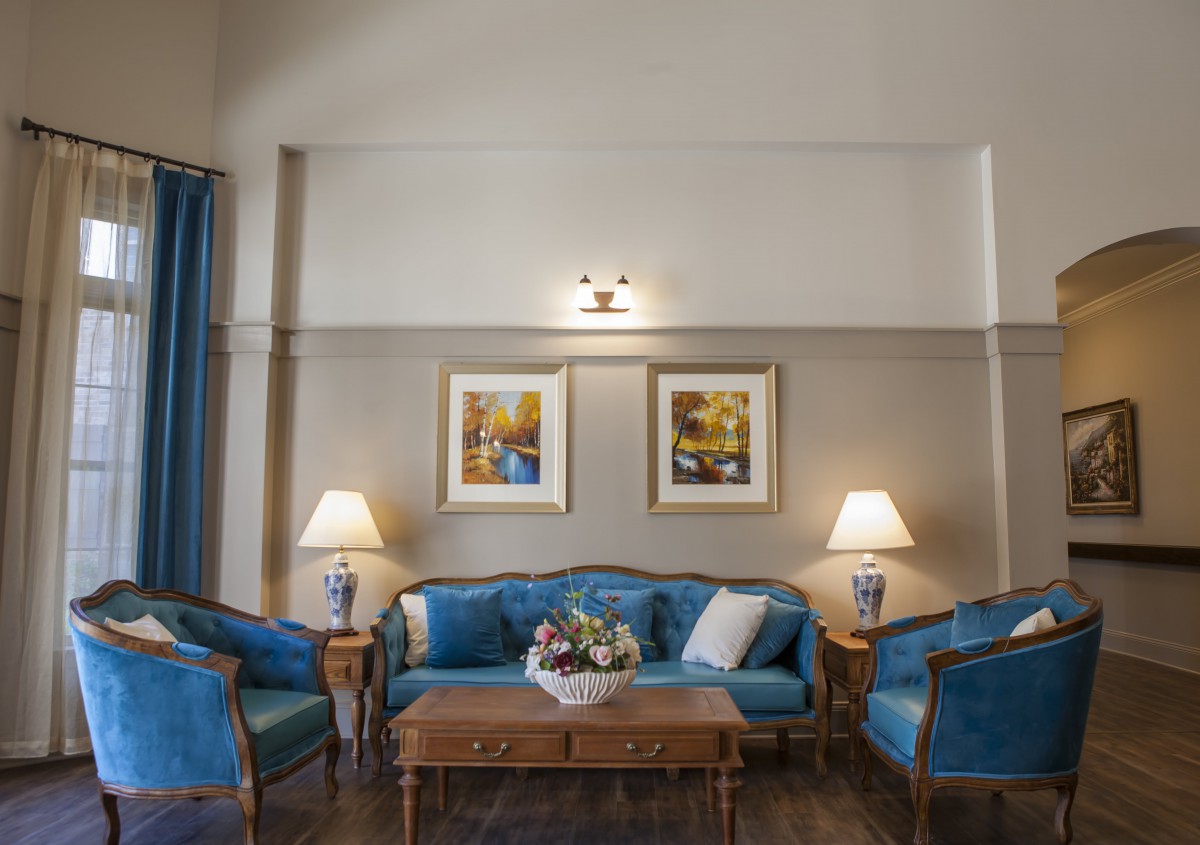 A classic living room setup with blue upholstered furniture and elegant decor.