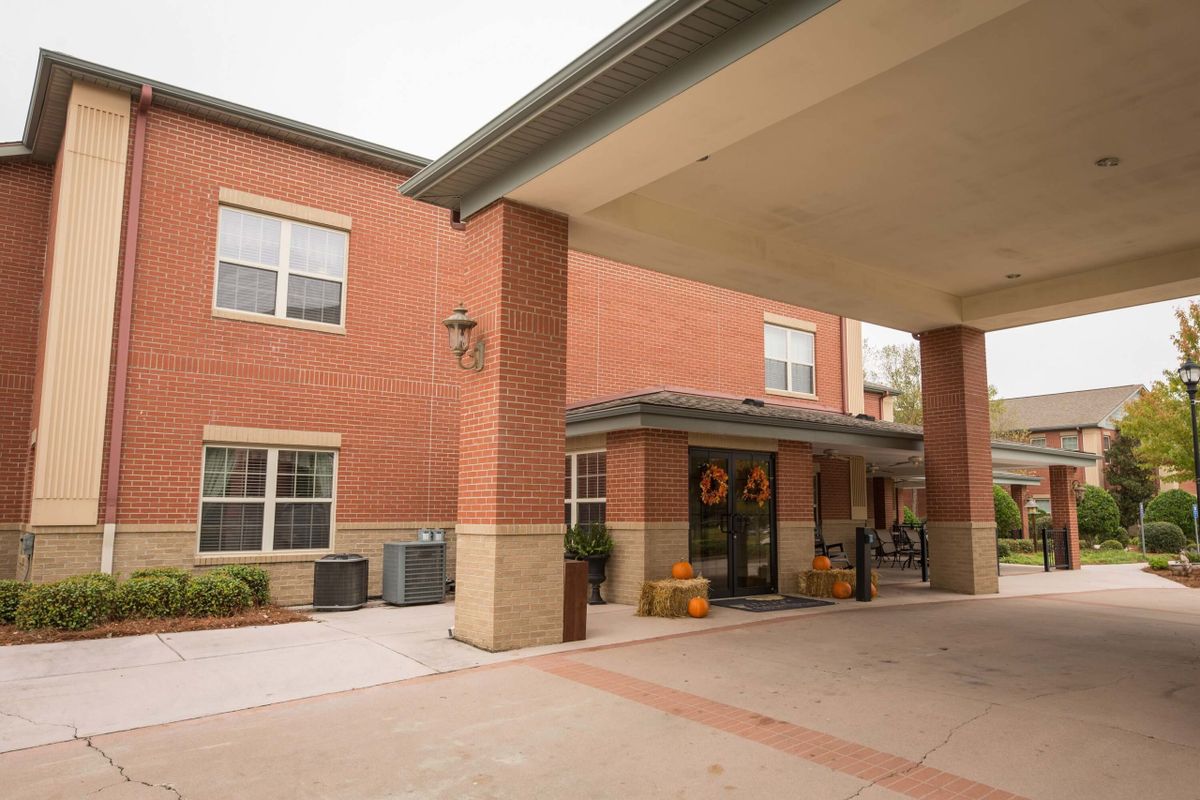 Entrance to a brick building with a covered driveway.