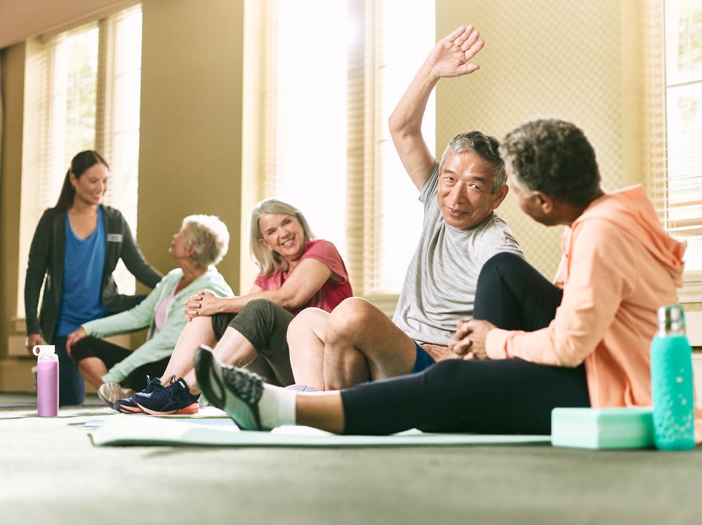 A group of seniors participating in a yoga class, enjoying exercise and camaraderie.