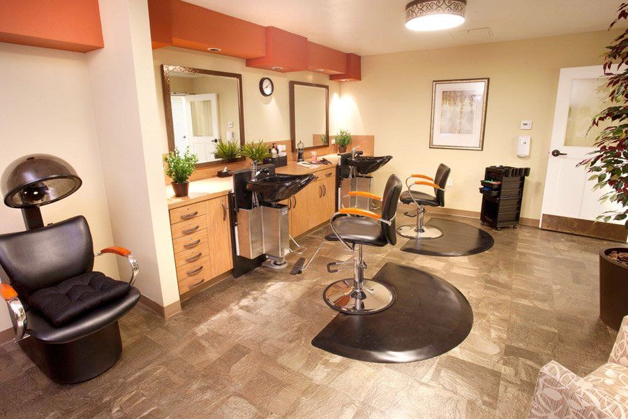 A modern hair salon interior with styling stations and mirrors.