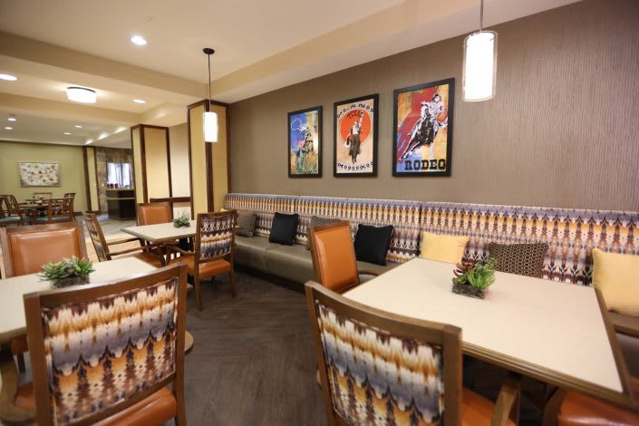 Cozy modern dining area with stylish artwork and seating.