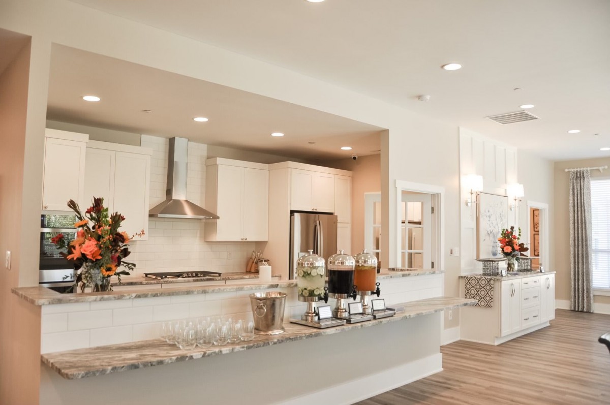 A modern kitchen featuring stainless steel appliances and marble countertops in an open-concept design.
