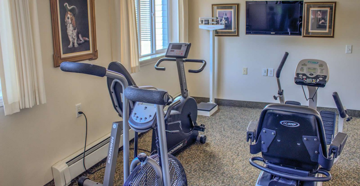 A small home gym with stationary bikes and fitness equipment.