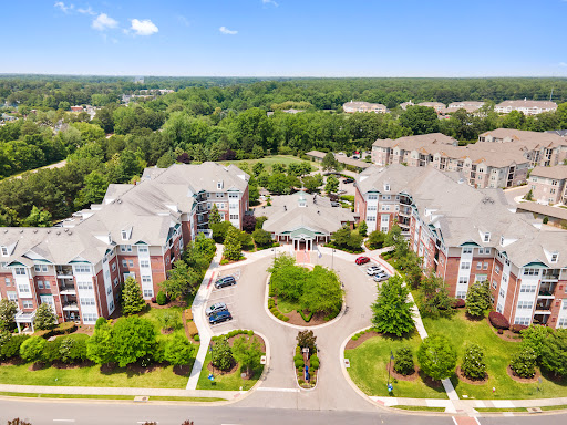 An aerial view of a well-maintained apartment complex surrounded by lush greenery.