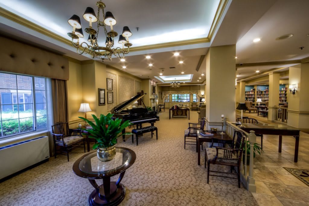 A luxurious lobby with a grand piano and elegant seating arrangements.