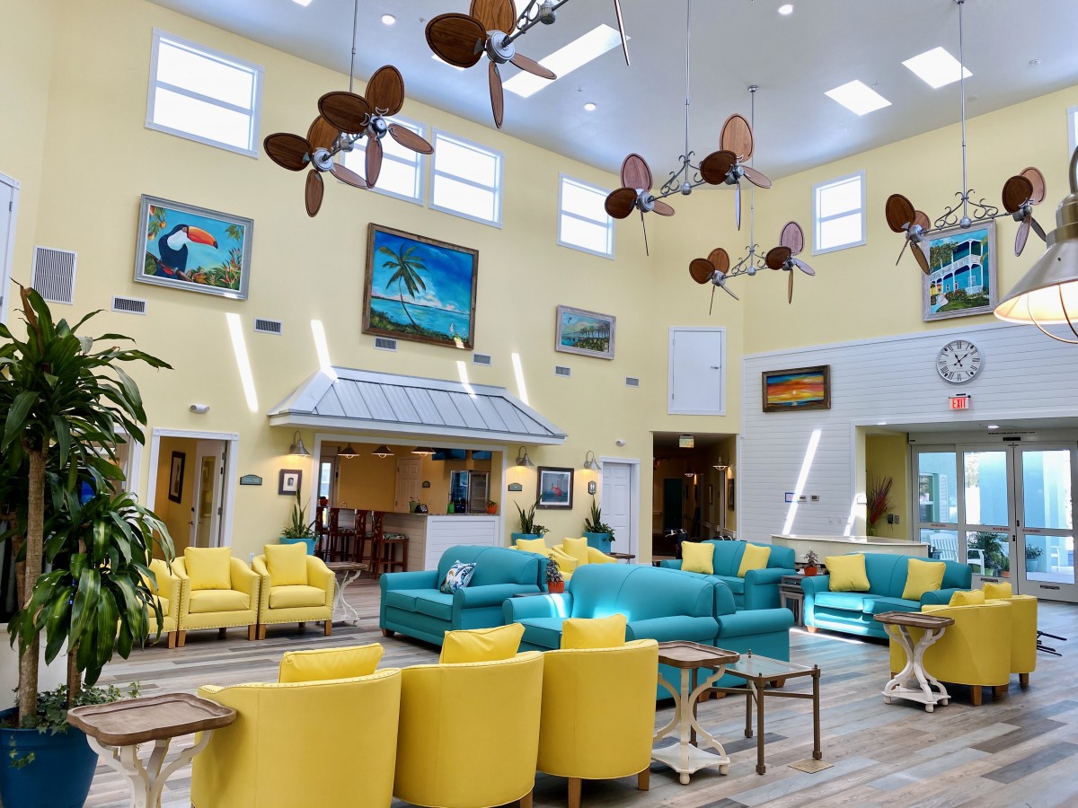 A vibrant and modern lobby with colorful furniture and decorative ceiling fans.