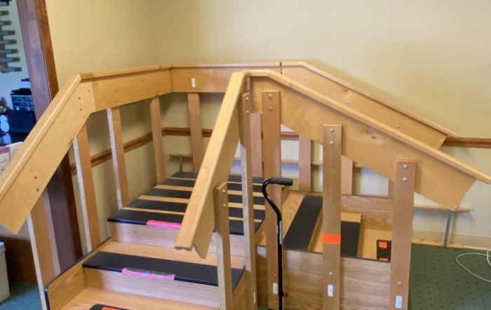 A wooden indoor staircase used for physical therapy and rehabilitation exercises.