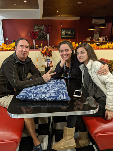 A happy family enjoying a meal together at a cozy restaurant.