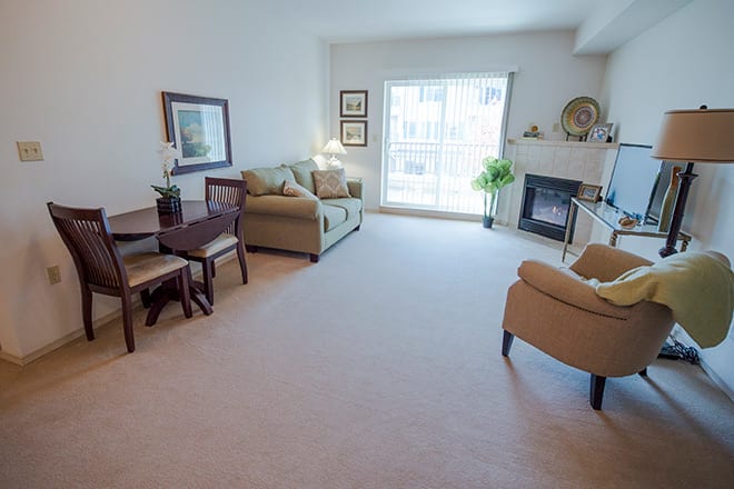 A cozy living room with comfortable seating and a fireplace.