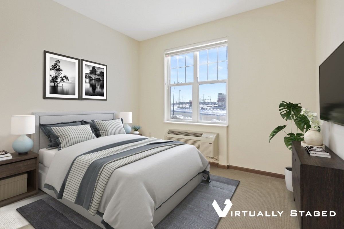 A minimalist bedroom with a neatly made bed and large window.