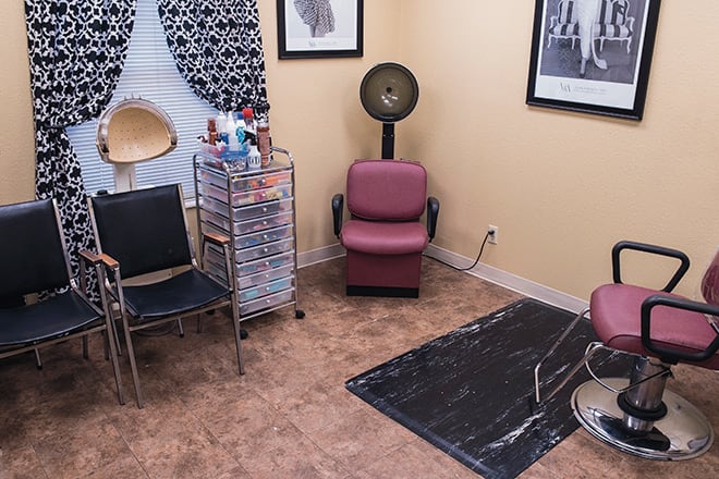 A cozy salon room with hairdressing equipment and stylish decor.