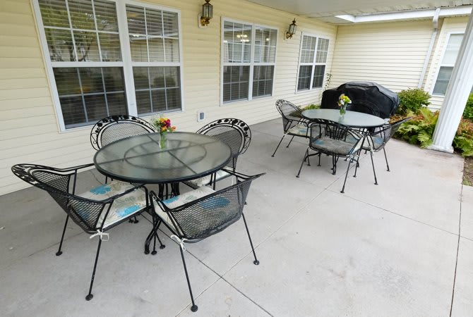 A cozy outdoor patio area with tables and chairs, perfect for gatherings.