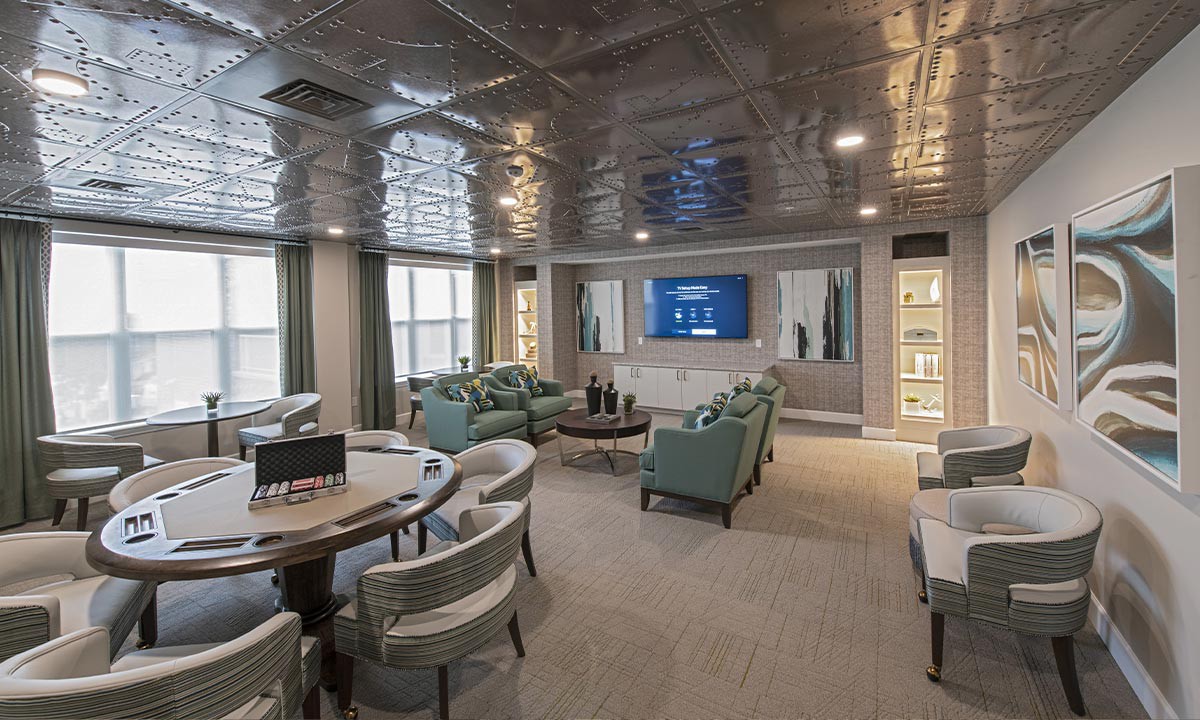 A modern lounge with stylish seating and a large TV, creating a comfortable and contemporary living space.