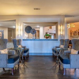 A modern and luxurious lobby seating area with stylish decor and comfortable chairs.
