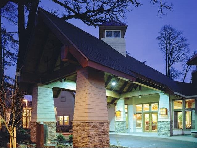 A modern building entrance illuminated during the evening.