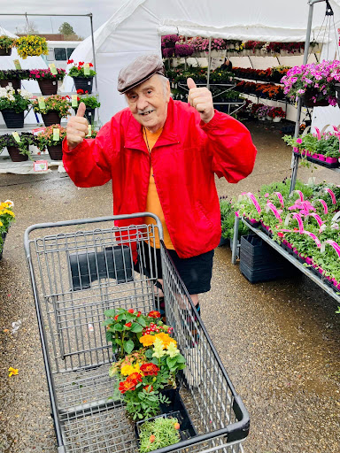 An enthusiastic shopper enjoying a day at the flower market.