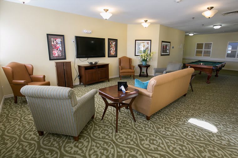 A cozy living room with comfortable seating and a large television.