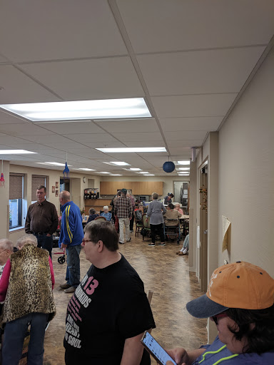 A busy indoor space filled with people engaged in various activities.