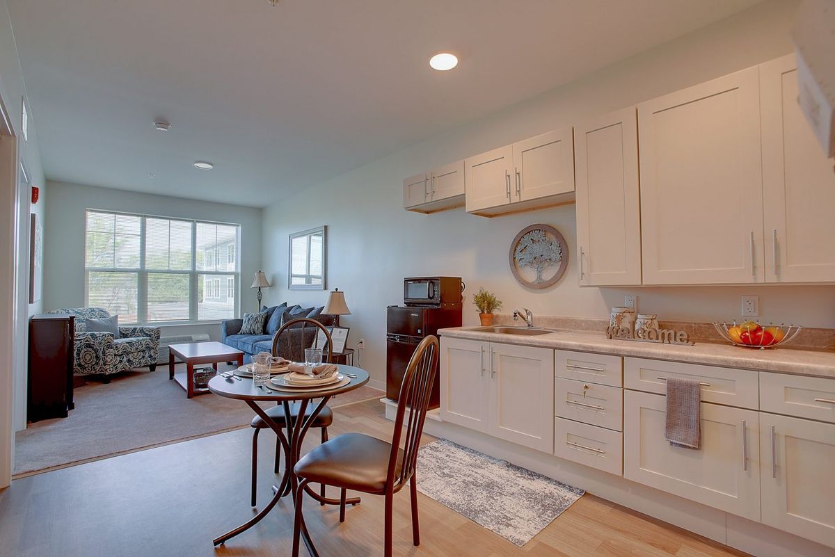 An open-plan kitchen and living area with cozy furniture and natural light.